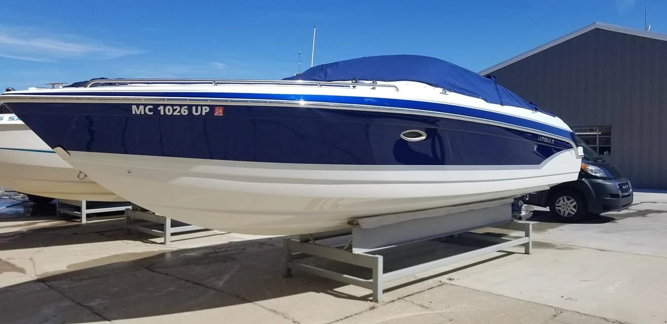 Boat detailing service on a blue and white motorboat